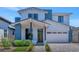 Charming two-story home featuring a white exterior, blue accents, and a welcoming covered entrance at 6743 N 9Th Dr, Phoenix, AZ 85013