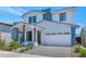 Stylish two-story home with a white garage door, blue accents, and well-maintained landscaping at 6743 N 9Th Dr, Phoenix, AZ 85013