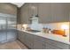 Modern kitchen featuring stainless steel refrigerator, sleek cabinets, and quartz countertops at 6743 N 9Th Dr, Phoenix, AZ 85013