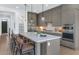 Modern kitchen with stainless steel appliances, quartz countertop island, and sleek pendant lighting at 6743 N 9Th Dr, Phoenix, AZ 85013