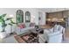Open-concept living room flows into a modern kitchen with an island and bar stools at 6743 N 9Th Dr, Phoenix, AZ 85013