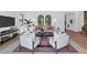 Bright and airy living room with stylish decor, comfortable seating, and hardwood floors at 6743 N 9Th Dr, Phoenix, AZ 85013