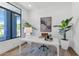 Bright office space with large windows, modern desk, and stylish decor accents and plants at 6743 N 9Th Dr, Phoenix, AZ 85013