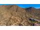 Aerial view of a luxury home nestled in the desert landscape at 6931 E Teton Cir, Mesa, AZ 85207