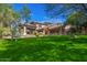 Lush backyard with verdant lawn, mature trees and desert landscaping at 6931 E Teton Cir, Mesa, AZ 85207