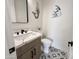 Stylish half-bathroom features a wooden vanity with modern fixtures and decorative accents at 6931 E Teton Cir, Mesa, AZ 85207