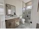 Modern bathroom with decorative tile floor, wood vanity, and glass-enclosed shower at 6931 E Teton Cir, Mesa, AZ 85207