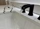 Waterfall faucet and white countertop create a modern, spa-like sink at 6931 E Teton Cir, Mesa, AZ 85207