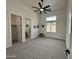 Spacious bedroom with neutral carpet, ceiling fan, and ensuite bathroom at 6931 E Teton Cir, Mesa, AZ 85207