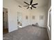 Spacious bedroom with neutral carpet, ceiling fan, and ensuite bathroom at 6931 E Teton Cir, Mesa, AZ 85207