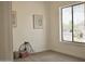 Neutral bedroom featuring carpet and an art print near a window with neighborhood view at 6931 E Teton Cir, Mesa, AZ 85207