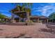 Beautiful clubhouse featuring stone columns, a tiled roof, and lush landscaping at 6931 E Teton Cir, Mesa, AZ 85207