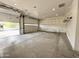 Spacious two-car garage with ample storage shelving and a high ceiling at 6931 E Teton Cir, Mesa, AZ 85207