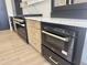 Stainless steel gas cooktop and oven with light wood and black cabinets and white countertops at 6931 E Teton Cir, Mesa, AZ 85207