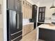A kitchen featuring black stainless appliances, two-tone modern cabinetry, and stylish countertops at 6931 E Teton Cir, Mesa, AZ 85207