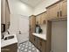 Bright laundry room with patterned floors, built-in cabinetry, and white countertops at 6931 E Teton Cir, Mesa, AZ 85207