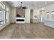 Spacious living room with an electric fireplace, wood accent wall, wood flooring, and recessed lighting at 6931 E Teton Cir, Mesa, AZ 85207