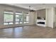 Bright living room with large windows, hardwood floors, backyard views, and an electric fireplace at 6931 E Teton Cir, Mesa, AZ 85207