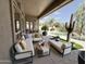 Inviting covered patio with comfortable seating overlooking a refreshing pool and lush landscaping at 6931 E Teton Cir, Mesa, AZ 85207