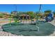 Community playground with climbing structures and green safety ground covering at 6931 E Teton Cir, Mesa, AZ 85207