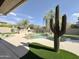 Inviting backyard pool with mature landscaping and a large saguaro cactus sculpture at 6931 E Teton Cir, Mesa, AZ 85207