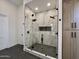 Luxurious marble shower with dual shower heads and sleek black fixtures at 6931 E Teton Cir, Mesa, AZ 85207