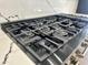 Close-up of a modern gas stove, highlighting stainless steel details and cooking elements at 6931 E Teton Cir, Mesa, AZ 85207