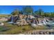 Picturesque water feature with natural rocks and cascading waterfalls at 6931 E Teton Cir, Mesa, AZ 85207