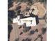 An aerial view of the property, displaying a large white roof and an uniquely designed outdoor pool area with desert landscaping at 6936 E Wethersfield Rd, Scottsdale, AZ 85254