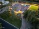 Overhead shot of backyard with pool, sport court, mature landscaping and house at dusk at 7129 E Caron Dr, Paradise Valley, AZ 85253
