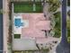 Overhead shot of a large home with a manicured lawn, pool, and landscaped grounds in a serene setting at 7129 E Caron Dr, Paradise Valley, AZ 85253