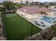Aerial view of backyard with pool, spa, fire pit, and a sports court for luxurious outdoor recreation at 7129 E Caron Dr, Paradise Valley, AZ 85253