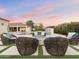 Beautiful backyard featuring a fire pit, comfortable seating, lush landscaping, a pool and cascading waterfall at 7129 E Caron Dr, Paradise Valley, AZ 85253