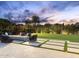 Backyard featuring pavers, a fire pit with seating, green grass, and manicured landscaping at 7129 E Caron Dr, Paradise Valley, AZ 85253