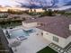 Aerial view of a backyard with a pool, spa, fire pit, and manicured landscaping for luxurious outdoor living at 7129 E Caron Dr, Paradise Valley, AZ 85253