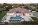 Aerial view of a backyard featuring a pool, spa, and outdoor seating area with mature landscaping at 7129 E Caron Dr, Paradise Valley, AZ 85253