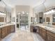 Bathroom featuring dual vanities, decorative mirrors, and tile flooring for a spa-like experience at 7129 E Caron Dr, Paradise Valley, AZ 85253