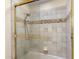 Bathroom featuring a glass shower door and tiled walls, plus a built in soap tray at 7129 E Caron Dr, Paradise Valley, AZ 85253