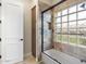 Bathroom featuring glass block window in shower/tub, plus linen closet and decorative tile at 7129 E Caron Dr, Paradise Valley, AZ 85253