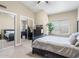 Spacious bedroom featuring mirrored closet doors, neutral paint, a large bed and dresser at 7129 E Caron Dr, Paradise Valley, AZ 85253