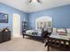 Bedroom with 2 beds, blue walls, carpet, ceiling fan, large window, and a decorative wall painting at 7129 E Caron Dr, Paradise Valley, AZ 85253