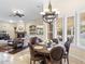 Inviting breakfast nook open to the living room featuring a chandelier and large windows with outdoor views at 7129 E Caron Dr, Paradise Valley, AZ 85253
