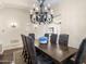 Spacious dining room featuring a large wooden table, upholstered chairs, and an elegant chandelier at 7129 E Caron Dr, Paradise Valley, AZ 85253