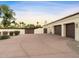 Spacious driveway leading to a three-car garage, complemented by desert landscaping and a private entrance at 7129 E Caron Dr, Paradise Valley, AZ 85253