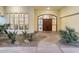 Grand entryway with decorative wood doors, and desert landscaping at 7129 E Caron Dr, Paradise Valley, AZ 85253