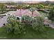 Expansive home exterior surrounded by lush greenery, a well-manicured lawn, and mature trees for a private setting at 7129 E Caron Dr, Paradise Valley, AZ 85253