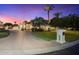 Elegant home featuring a circular driveway, lush lawn, and well-manicured landscaping at dusk at 7129 E Caron Dr, Paradise Valley, AZ 85253