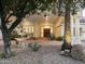 Elegant home featuring a stone fountain, lush landscaping, and a grand entrance with stately columns at 7129 E Caron Dr, Paradise Valley, AZ 85253