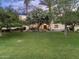 Expansive front yard featuring a well-maintained lawn and mature trees offering shade and curb appeal at 7129 E Caron Dr, Paradise Valley, AZ 85253