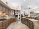 Open kitchen featuring granite countertops, custom cabinetry, and stainless steel appliances, leading to the living area at 7129 E Caron Dr, Paradise Valley, AZ 85253